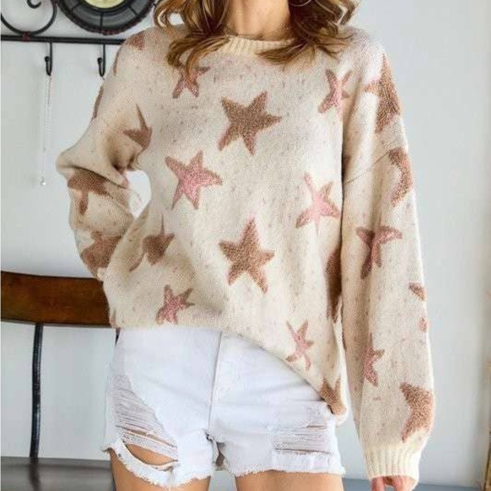 Cream knit sweater with star detail.